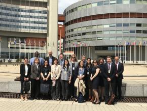 Group of participants on FATF-Private-Consultative-Forum (16 persons). In the background some modern office buildings.