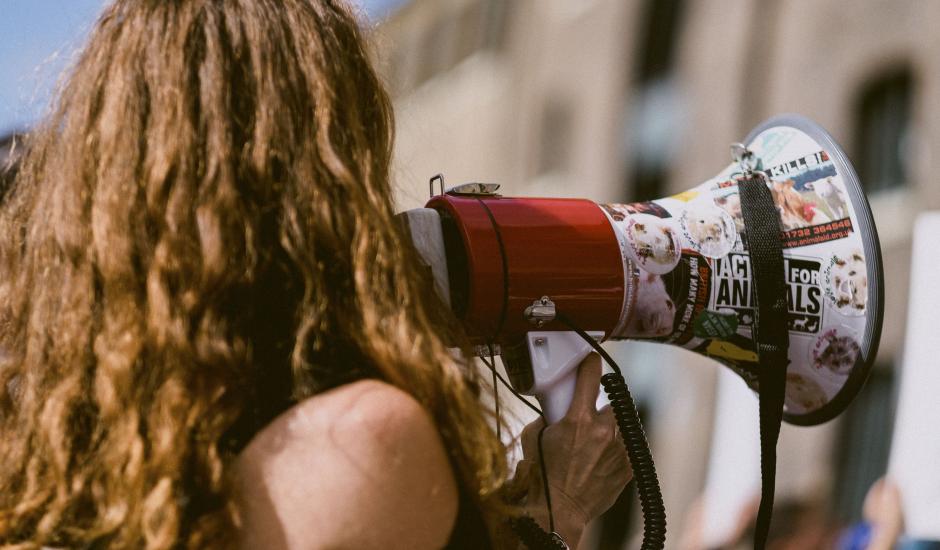 female protester holding megaphone