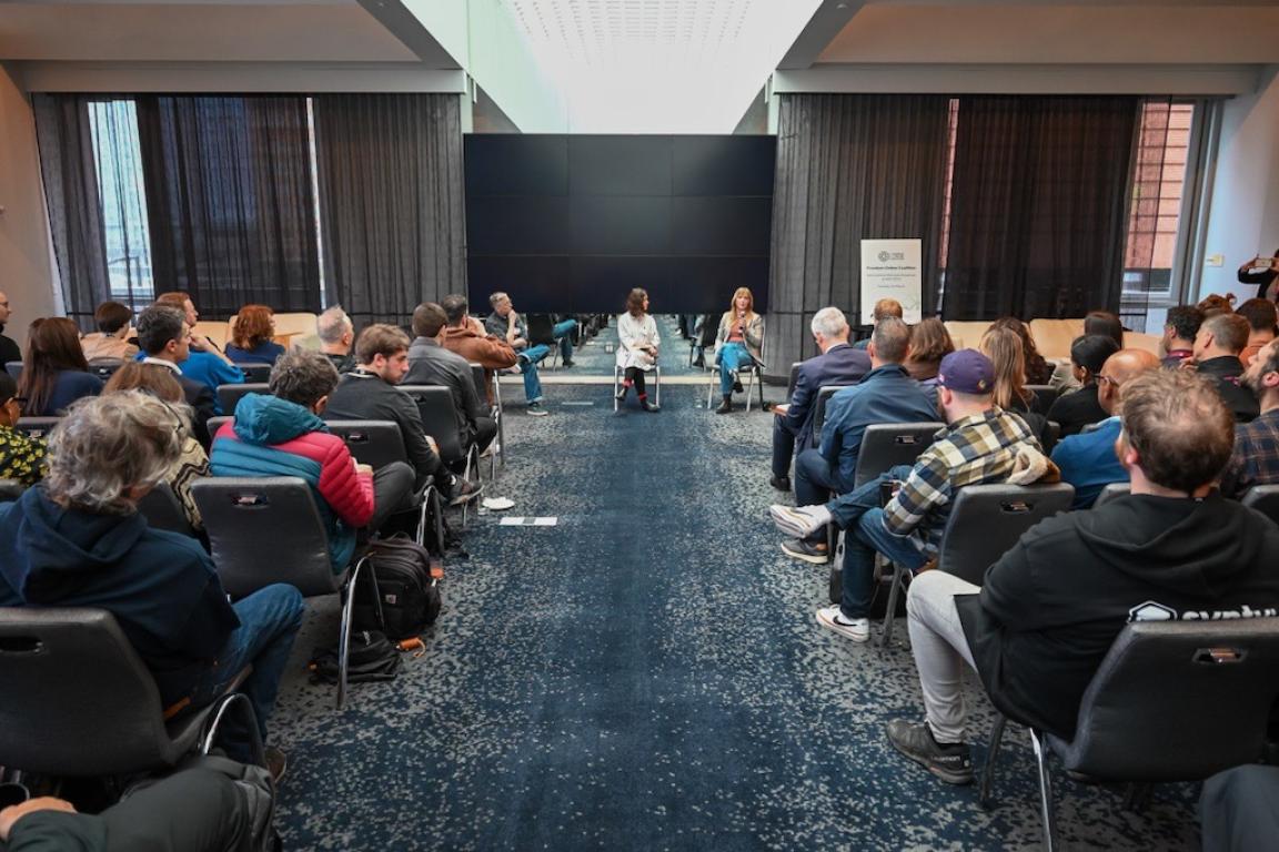 panel of speakers sitting in front of audience at the ECNL - Freedom Online Coalition welcome breakfast at Game Developers Conference