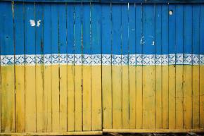 fence pained with colors of Ukrainian flag